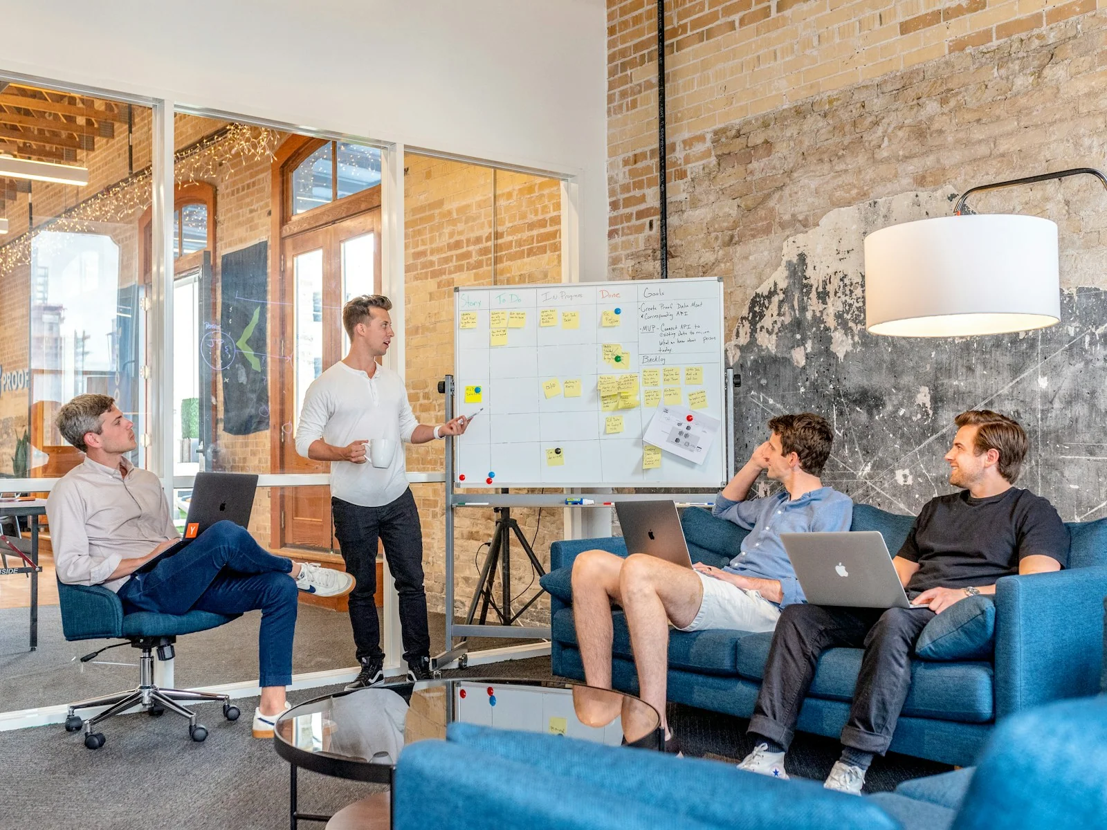 Marketing and sales team reviewing a pipeline dashboard in warm natural light